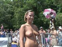 A bunch of people look on as a nude girl struts on a stage at a show - movie 1 - 7