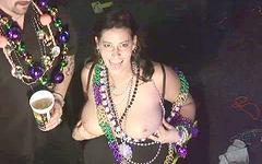 Christine wears many beads and rubs her breasts join background