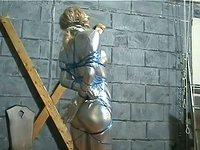 Blonde with big boobs in form-fitting silver jumpsuit is tied up in bondage - movie 12 - 5