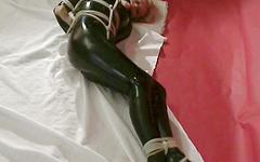 Watch Now - Blonde with big boobs in a latex jumpsuit is severely hogtied in bdsm scene