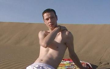 Download Sexy twink jock masturbates on a sand dune while sunbathing