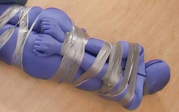 Scaricamento Completely encased female is bound with duct tape in bdsm bondage scene