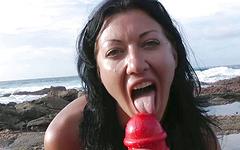 Slutty brunette stretches her ass with a massive dildo on the beach - movie 1 - 6