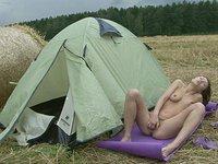 Slutty whore rubs her hairy pussy outside next to her tent. - movie 5 - 3