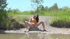 Susan plays with her wet pussy sitting on a rock at a secluded lake - movie 5 - 5